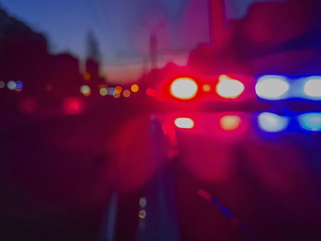 Red and blue Lights of police car in night time. Night patrolling the city. Abstract blurry image.