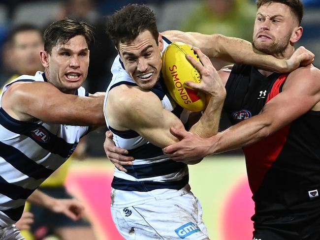 GEELONG, AUSTRALIA - JULY 02: Jeremy Cameron of the Cats is tackled by Jayden Laverde of the Bombers during the round 16 AFL match between Geelong Cats and Essendon Bombers at GMHBA Stadium on July 02, 2021 in Geelong, Australia. (Photo by Quinn Rooney/Getty Images)