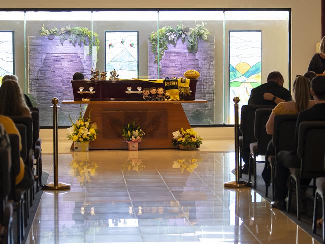 Friends and family of stabbing victim Declan Laverty are dressed in black and yellow in honour of Declan’s favourite AFL team, the Richmond Tigers, as they attend his funeral memorial service in Cairns. Picture: NCA NewsWire/Emily Barker