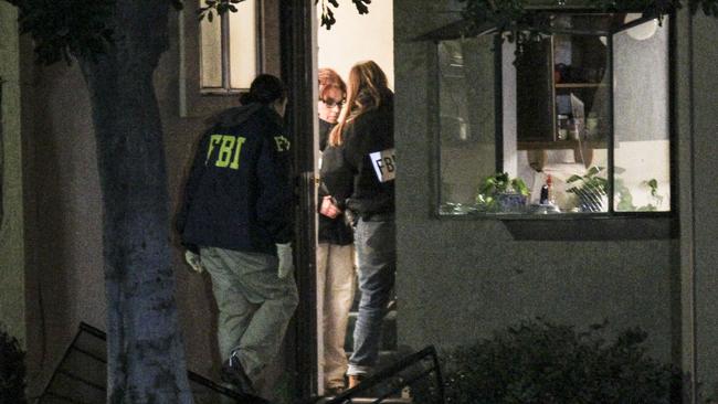 Suburban nightmare ... FBI agents search  the house where the couple lived.