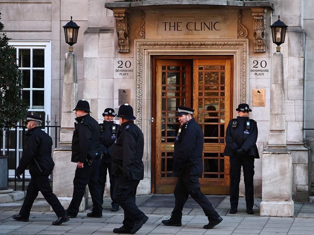 Police officers stand guard outside the entrance to London Clinic, where it was claimed Princess Catherine was placed in an induced coma. Picture: AFP