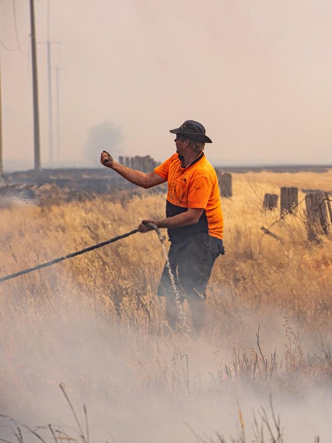 Locals helped to protect properties. Picture: Jason Edwards