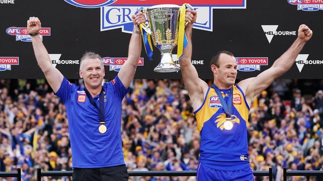 West Coast coach Adam Simpson and captain Shannon Hurn hold up the premiership cup.