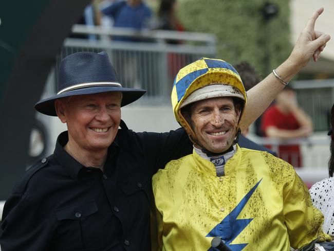 Australian jockey Hugh Bowman, right, poses with trainer John Moore after riding Hong Kong horse " Werther " to win the Audemars Piguet QEII Cup at the Sha Tin race course in Hong Kong Sunday, April 24, 2016. (AP Photo/Vincent Yu)