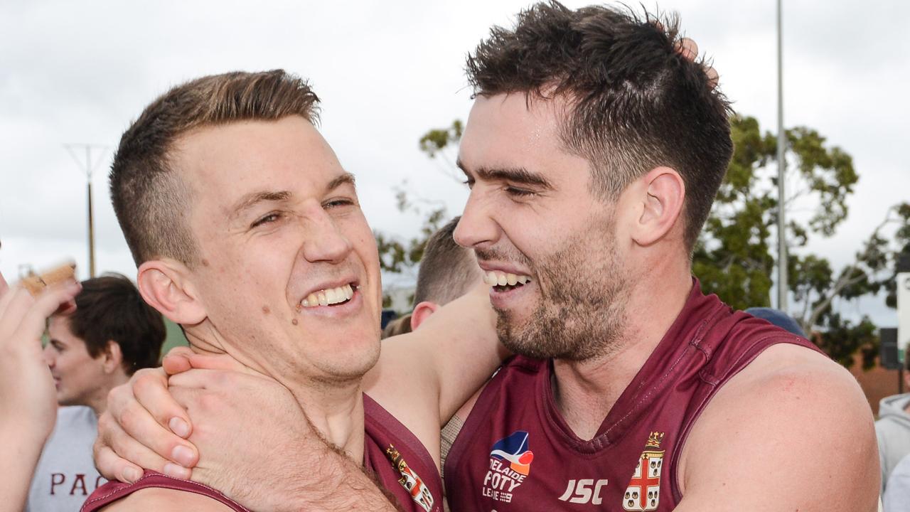 Jack Trengove and teammate Cameron Giles celebrate after winning the Adelaide Footy League division one grand final between Prince Alfred Old Collegians and Payneham Norwood Union at Richmond Oval. Picture: Brenton Edwards