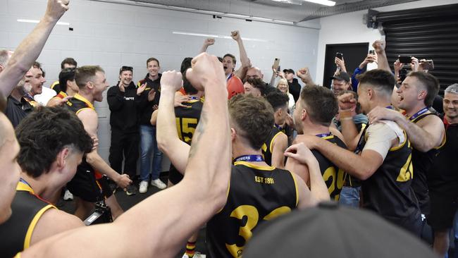 Cheltenham sing the song in the rooms after the win. Picture: Andrew Batsch