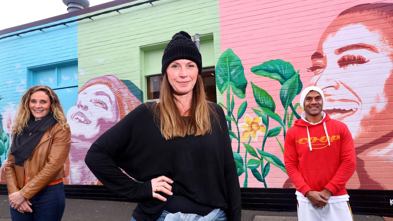 Geelong West has been splashed with an injection of colour and three emotive faces, thanks to a huge 10 metre mural, on the wall of Bakers Delight on Pakington Street. Left: Belinda White (Studio Director, Bells Fine Art), artist Kirstin Walsh and Bakers Delight Geelong West owner Suranga Sena (who survived a rare brain condition). Picture: Glenn Ferguson