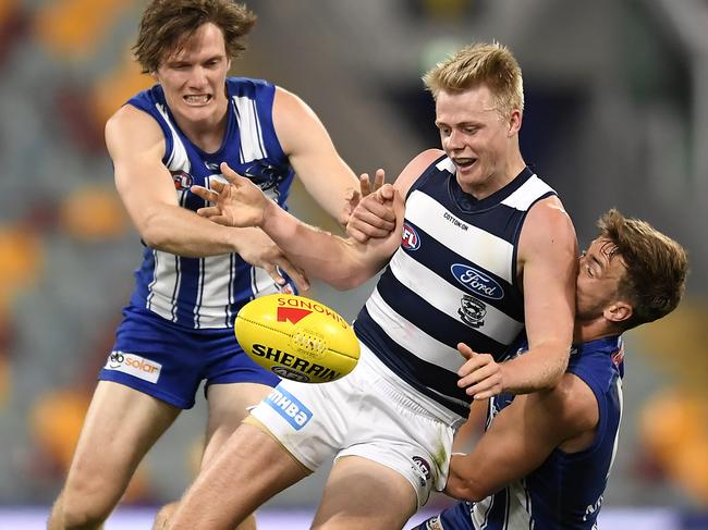 BRISBANE, AUSTRALIA - AUGUST 05: Zach Guthrie of the Cats is tackled during the round 10 AFL match between the Geelong Cats and the North Melbourne Kangaroos at The Gabba on August 05, 2020 in Brisbane, Australia. (Photo by Albert Perez/AFL Media/via Getty Images)