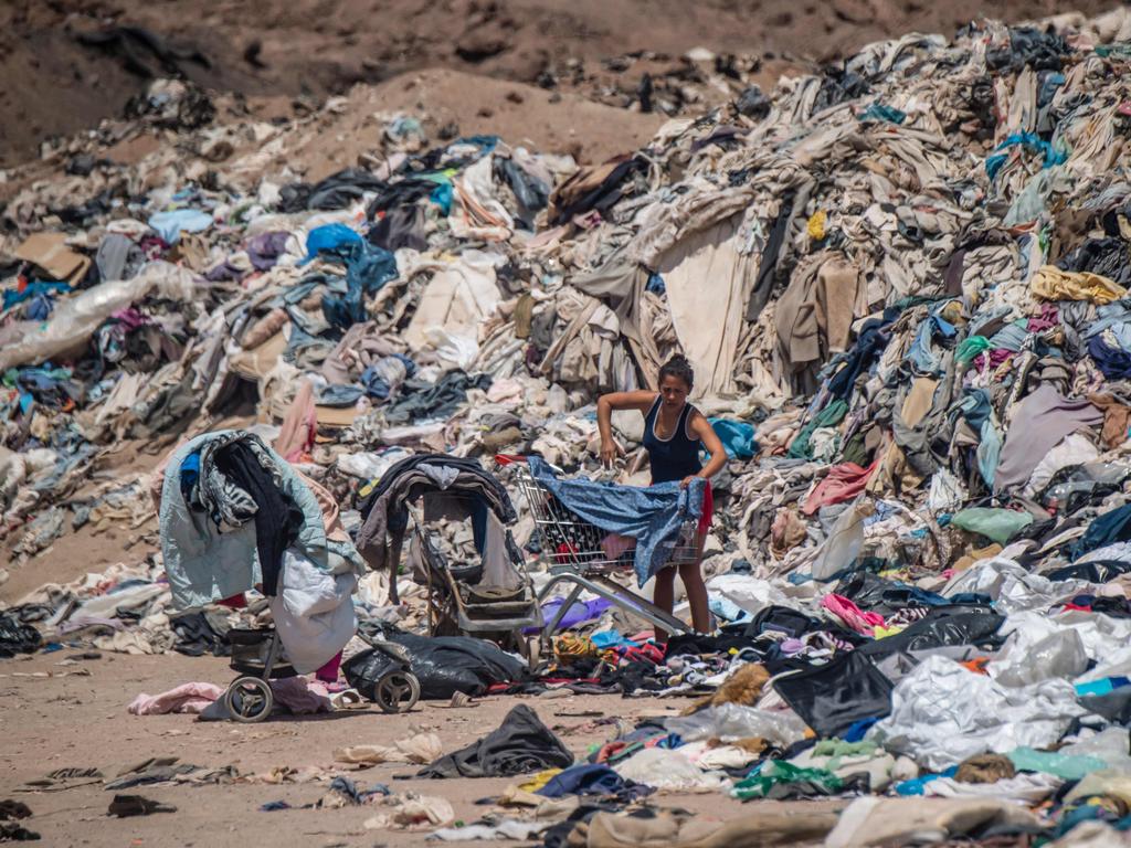 Women search for used clothes. Picture: Martin Bernetti/AFP