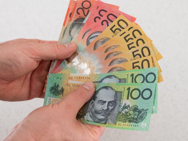 Man holding Australian money financial