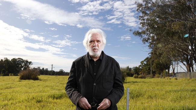 Planning expert Professor Leslie Stein at the empty field in Leppington that should be a bustling metropolis now. Picture: Jonathan Ng