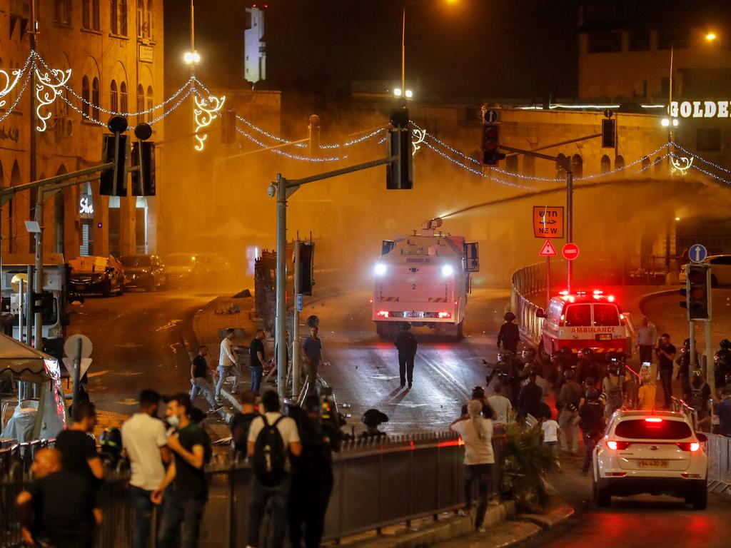 Israeli forces spray a crowd of Palestinian protesters outside the Damascus Gate in Jerusalem's Old City. Picture: Ahmad Gharabli/AFP