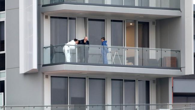 Police on a balcony at the scene where a woman was found dead. Picture: Damian Shaw