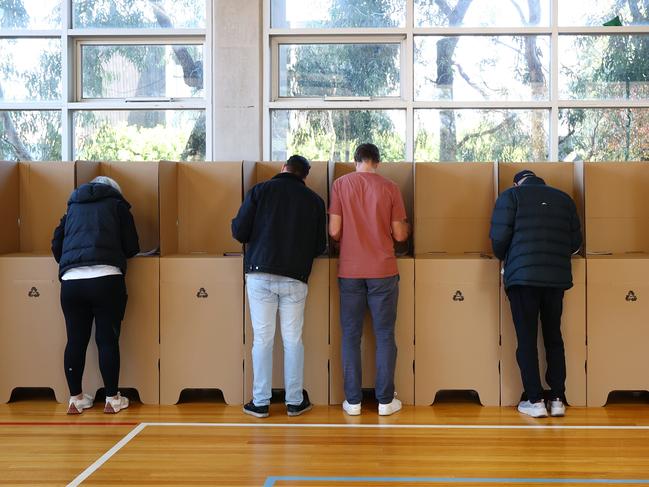 MELBOURNE, AUSTRALIA - MAY 03: People stand in voting booth at Kew Primary School in the seat of Kooyong on May 03, 2025 in Melbourne, Australia. Australians headed to the polls on Saturday for the 2025 federal election, where all 150 seats in the House of Representatives and 40 of 76 Senate seats are up for grabs. This election is especially consequential due to a tightly contested race, with cost-of-living pressures, affordable housing, and energy policy dominating the campaign. Though most polls indicate a narrow Labor victory against the Liberal-National coalition, the result could also lead to a hung parliament, reflecting the growing influence of independents and minor parties, and potentially reshaping the balance of power in Australia in the years ahead. (Photo by Morgan Hancock/Getty Images)