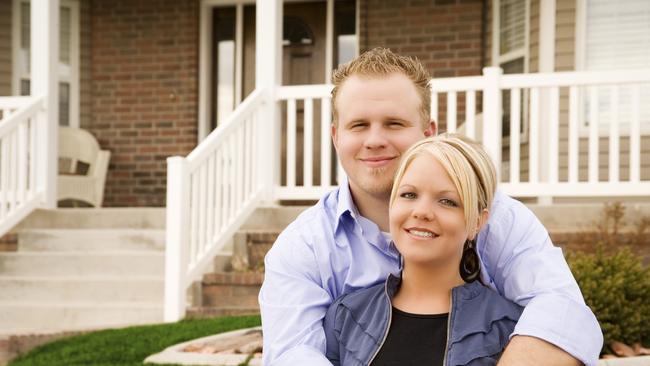Couple outside a new home and they are paying off their mortgage. Picture: iStock.