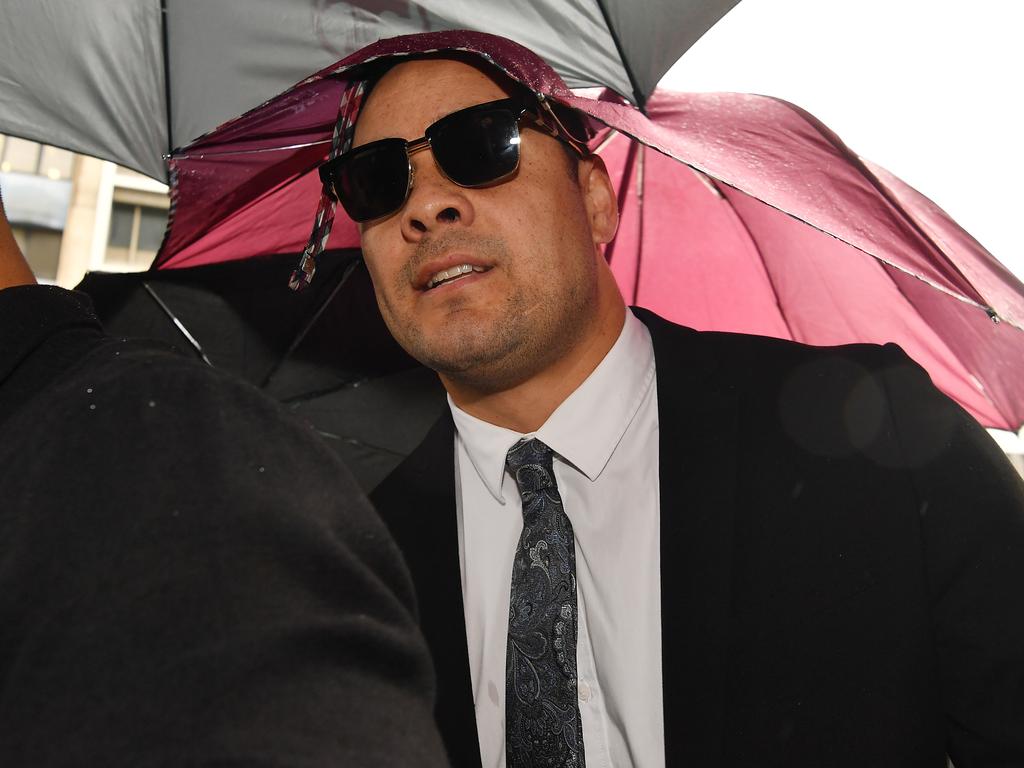 Jarryd Hayne arrives, surrounded by supporters, at Newcastle District Court.