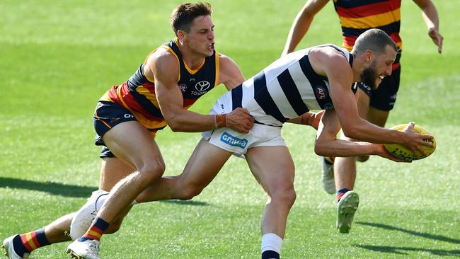 Sam Menegola of the Cats is tackled by Crows player Jake Kelly. Picture: Mark Brake/Getty Images