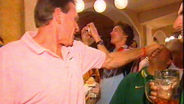 Sam Newman punches an Australian fan after being spat on, during a party in the Lowenbraukeller beer hall in Munich, Germany