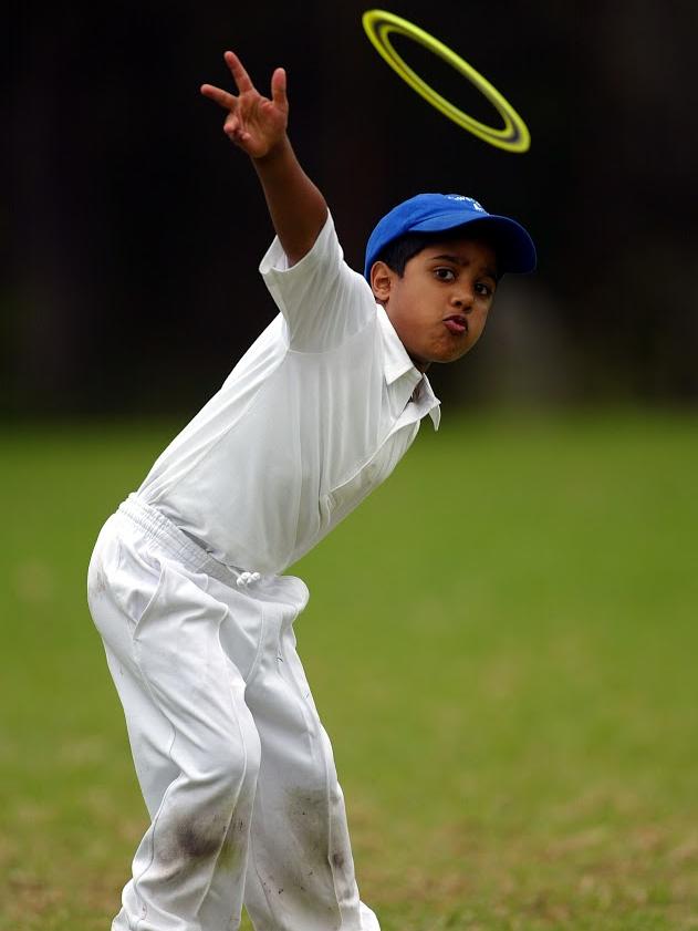 Child tossing a ring at a sport birthday party.