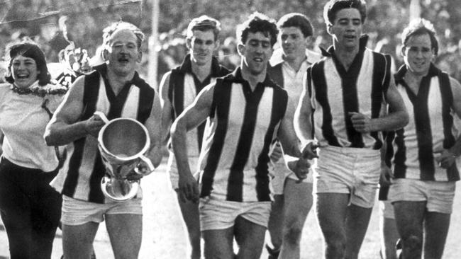 St Kilda players celebrate with a victory lap after winning the 1966 premiership.