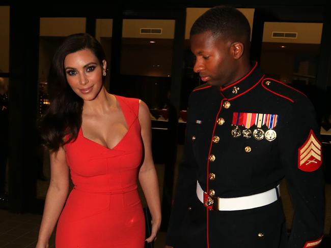 Kim Kardashian attends the Marine Corps Ball with Sgt Martin Gardner in Greenville, NC. Sgt Gardiner couldn't keep his eyes off his A-list date as they posed for photographs. Kim, wearing a stunning Roland Mouret red dress arrived at the ball and stayed for dinner before leaving solo and headed back to her hotel. Picture: Splash