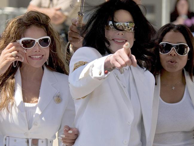 Michael Jackson flanked by singer sister Janet (R) &amp; La Toya as they leave Santa Maria courthouse in 2004 during a pre-trial hearing in Jackson's molestation case. Picture: Supplied