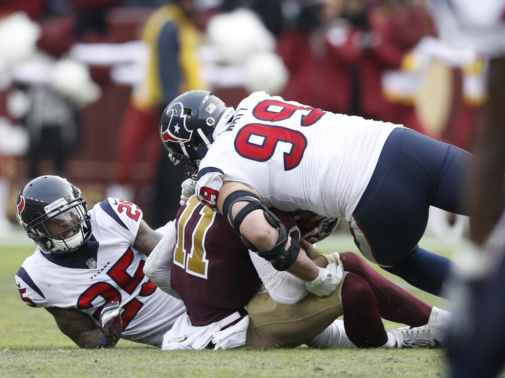 Smith smashed by two Texans defenders.