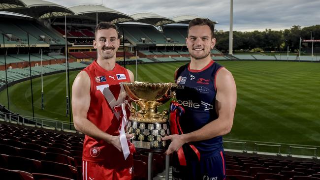 North Adelaide's Alex Spina and Norwood's Matthew Nunn with the premiership cup at Adelaide Oval. Picture: Roy VanDerVegt