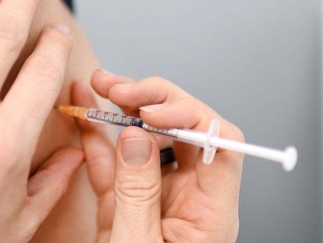 BRISBANE, AUSTRALIA - NewsWire Photos - AUGUST 8, 2021. A young man receives the AstraZeneca Covid-19 vaccine by pharmacist Michael Thorp at the Carina Day and Night pharmacy in Brisbane. Picture: NCA NewsWire / Dan Peled