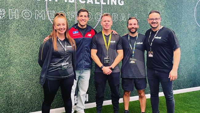 Melbourne star Jack Viney with staff at the new rebel store.