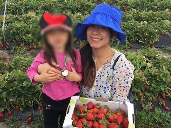 Evelin Kwok, with one of her daughters (face blurred).