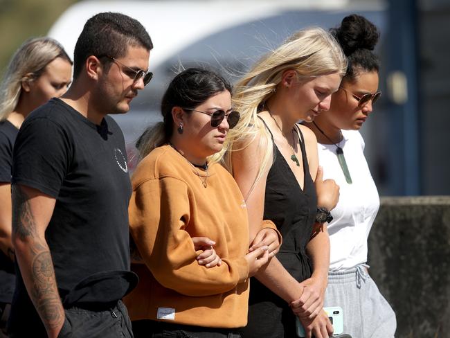 People grieving and comforting each other outside the Te Manuka Tutahi Marae. Picture: Phil Walter/Getty