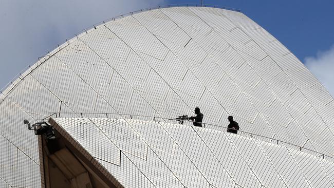 Police snipers are seen on the Sydney Opera House as they prepare for the arrival of Prince Harry and Meghan Markle Chris Jackson/Getty