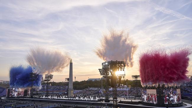 A general view as smoke is released in the colours of the French flag whilst dancers perform during the opening ceremony. (Photo by Aitor Alcalde/Getty Images)