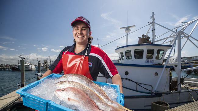 Fishmonger Dean Currie, from Fisheries on the Spit, with fresh snapper at Mooloolaba Wharf.