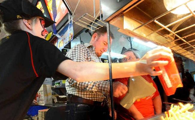 Coffs Coast Advocate general manager Brent Rees manhandles the chip baskets at McDonalds Coffs Harbour South. Picture: Leigh Jensen