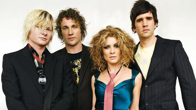 Natalie Bassingthwaighte with Cameron McGlinchey (second from left) and their Rogue Traders bandmates.