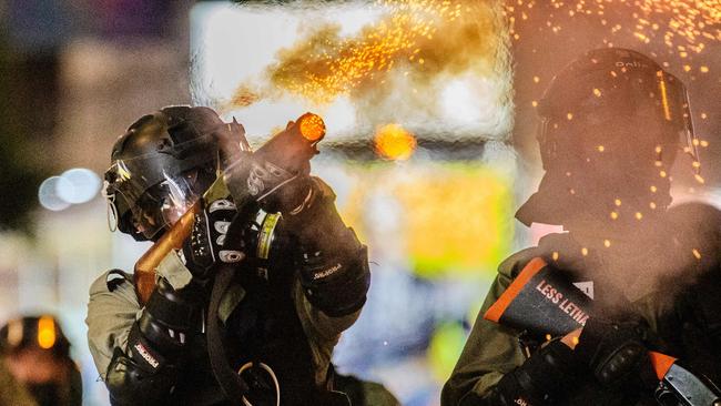 A member of the police fires tear gas towards residents and protesters in the Causeway Bay area of Hong Kong on November 2.