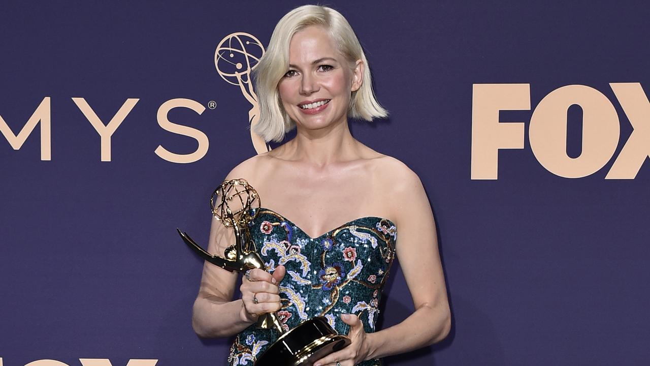 Michelle Williams poses in the press room with the award for outstanding lead actress in a limited series or movie for Fosse/Verdon. Picture: Jordan Strauss/Invision/AP