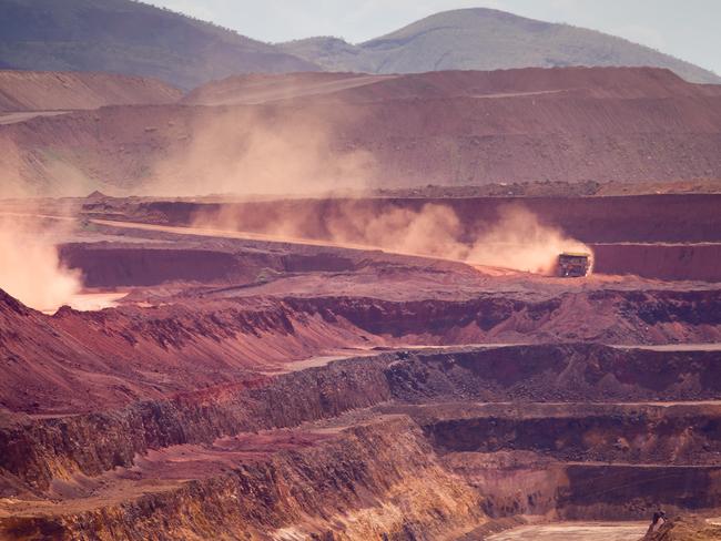 CREDIT: GETTY ONLINE USE ONLY Haul trucks operate in the pit at Rio Tinto Group's West Angelas iron ore mine in Pilbara, Australia, on Sunday, Feb. 19, 2012. Rio Tinto Group, the world's second-biggest iron ore exporter, will spend $518 million on the first driverless long-distance trains to haul the commodity from its Western Australia mines to ports, boosting efficiency. Photographer: Ian Waldie/Bloomberg via Getty Images