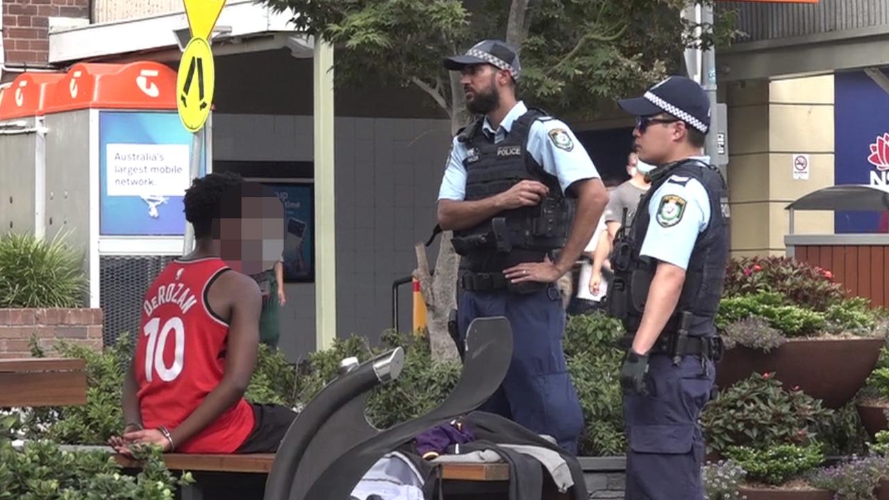 Police speak with one of the teens involved in the brawl after his arrest. Picture: TNV