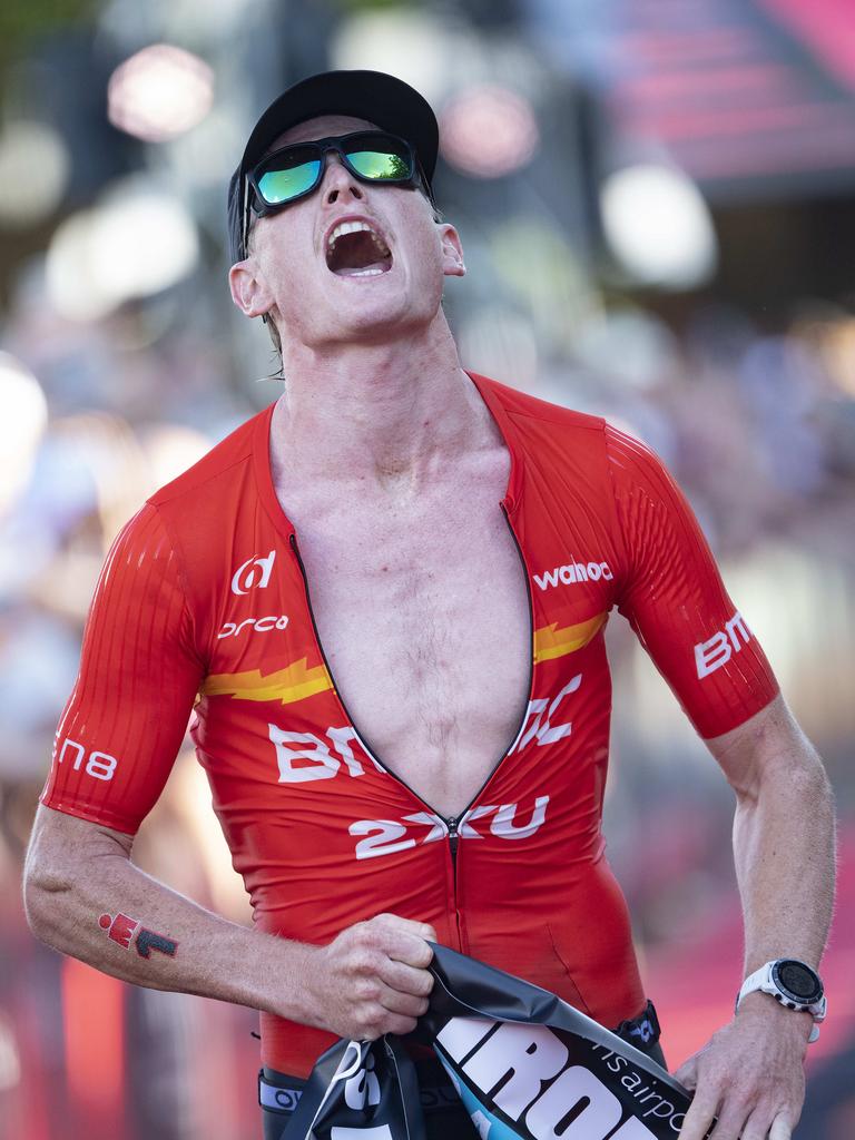 Cairns Iron Man - Winner Max Neumann ecstatic as he crosses the finish line in a new record time. Picture: Brian Cassey