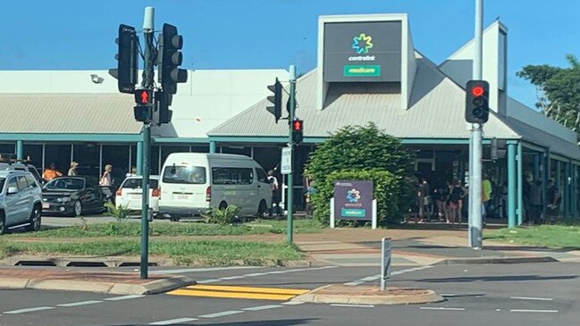 People lining up around the block at the Centrelink Palmerston office on Monday morning. Picture: Jarrod Goldoni