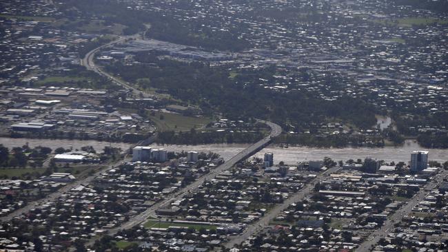 Low-lying properties are seen next to a swollen Fitzroy River in Rockhampton. Picture: AAP Image/Dan Peled