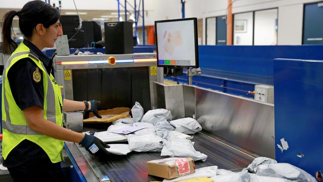 Australian Border Force officers check packages from overseas for illegal substances at the Australia Post processing facility. Picture: Damian Shaw