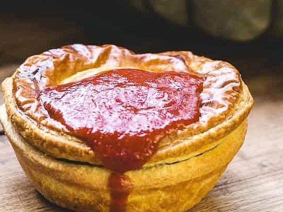 An Aussie meat pie with loads of tommo sauce. Yum!