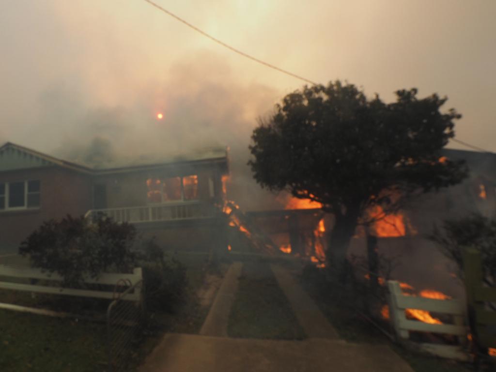 A bush fire rages in the town of Tathra on Sunday afternoon, March 18, 2018. Picture: John Ford