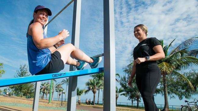 Clare Beacham and trainer Stephanie Jeans tryi out the new outdoor gym set up on Casuarina Drive. Picture: Glenn Campbell