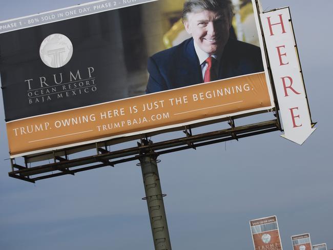 Trump has handed over running of his company to his sons, but experts say it remains a “grey” area. Pictured, Trump advertising homes for sale in the outskirts of Tijuana. Picture: AP Photo/Guillermo Arias, File.