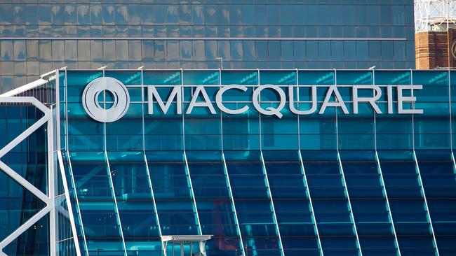 The Macquarie Group Ltd. logo is displayed on the facade of the Macquarie Group Building in Sydney, Australia, on Friday, April 27, 2012. Macquarie Group Ltd., Australia's largest investment bank, said it's relying on cost cuts to revive earnings after a slump in trading income and dealmaking dragged full-year net income to an eight-year low. Photographer: Ian Waldie/Bloomberg